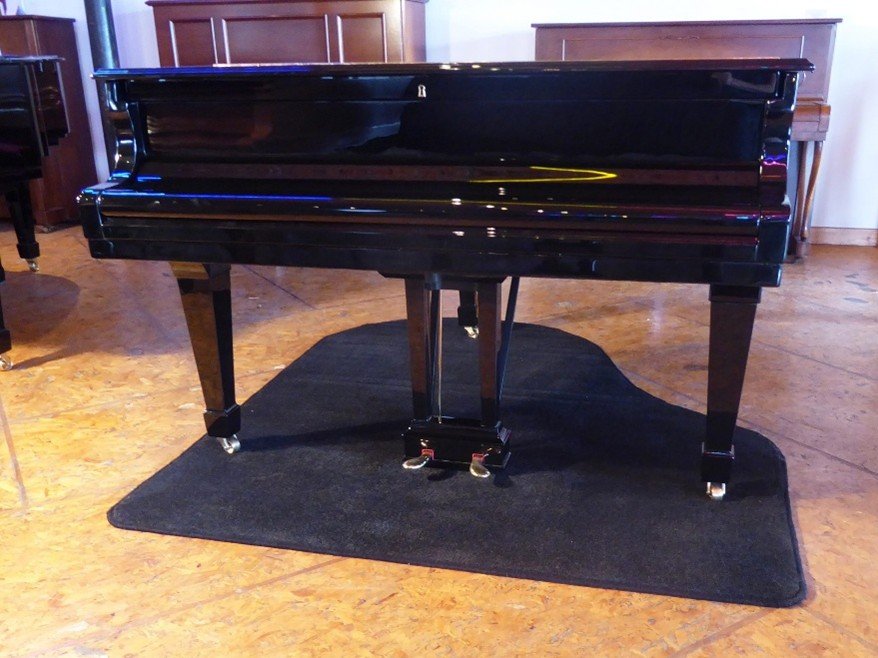 Piano removal team placing protective mats on floor