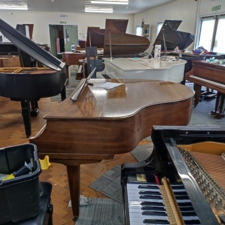 Upright and grand pianos side by side